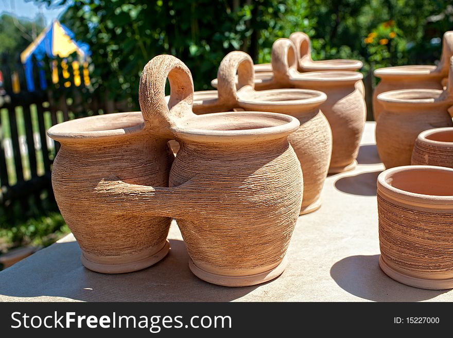 Old fashioned clay pots on grass