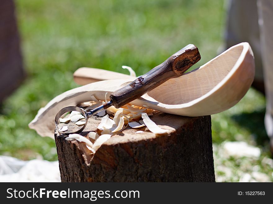 Hand carved wooden spoon with carving tools. Hand carved wooden spoon with carving tools