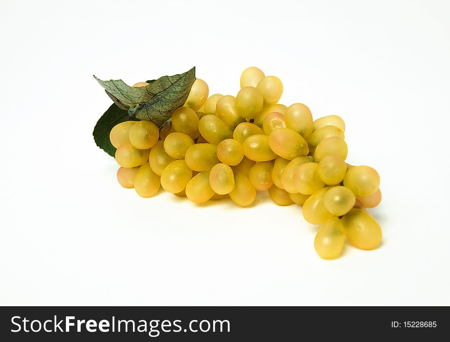 Fresh grape fruits with green leaves over white