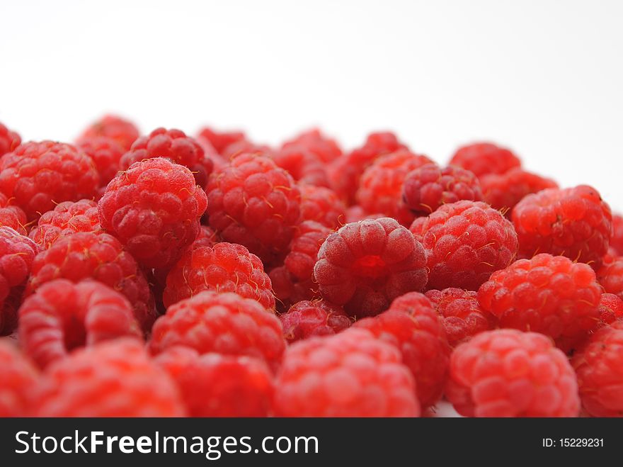 Closeup of many raspberries on a white background. Closeup of many raspberries on a white background