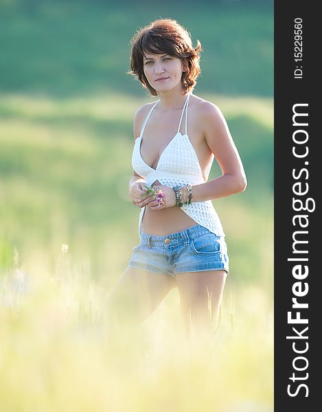 Photo of a young beautiful woman in a wheat field. Photo of a young beautiful woman in a wheat field