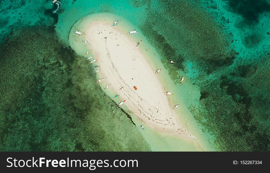 Sandy island with a beach and tourists. Naked Island, Siargao