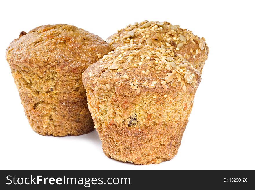 Three freshly baked muffins isolated on white.