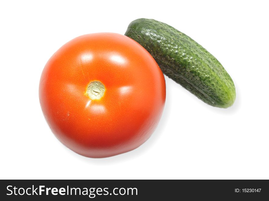 Red ripe tomato and a cucumber isolated on white background