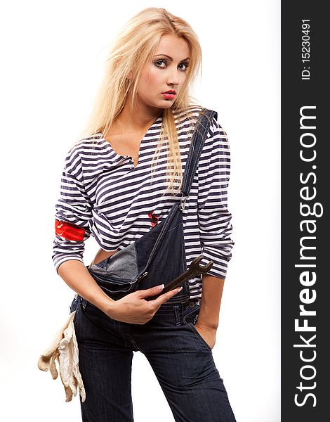 Beautiful blond woman in jeans with wrench. Beautiful blond woman in jeans with wrench