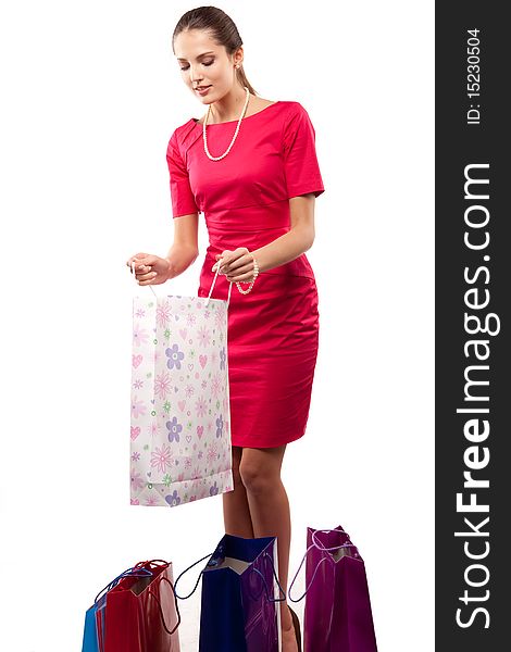 Young beautiful woman  in red dress with color packages. Young beautiful woman  in red dress with color packages