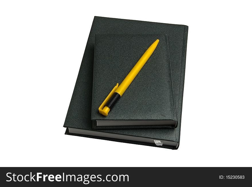 Two green notebooks and yellow pen