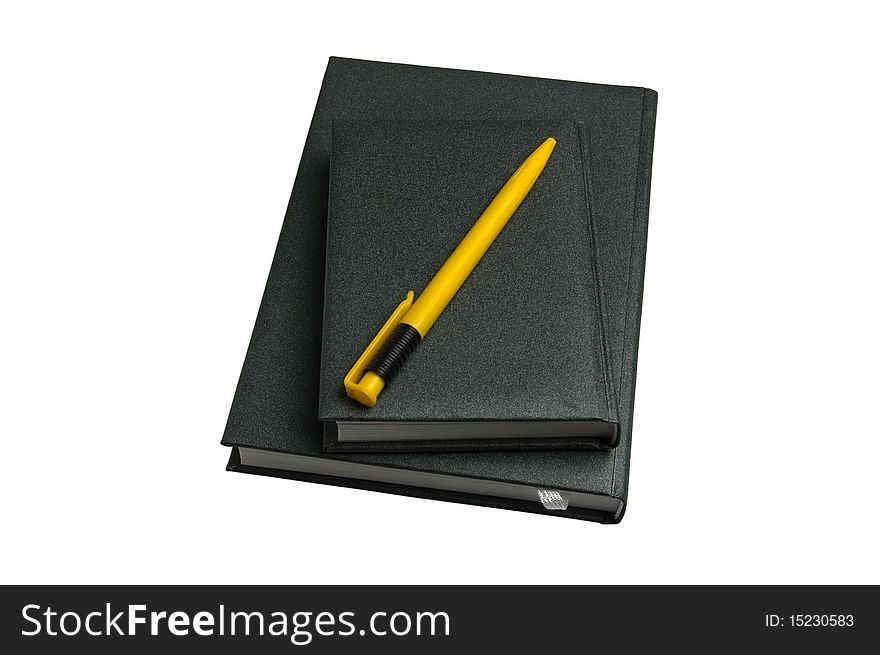 Two green notebooks and yellow pen isolated over white background