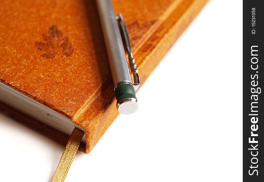 Diary notebook and pen on white background