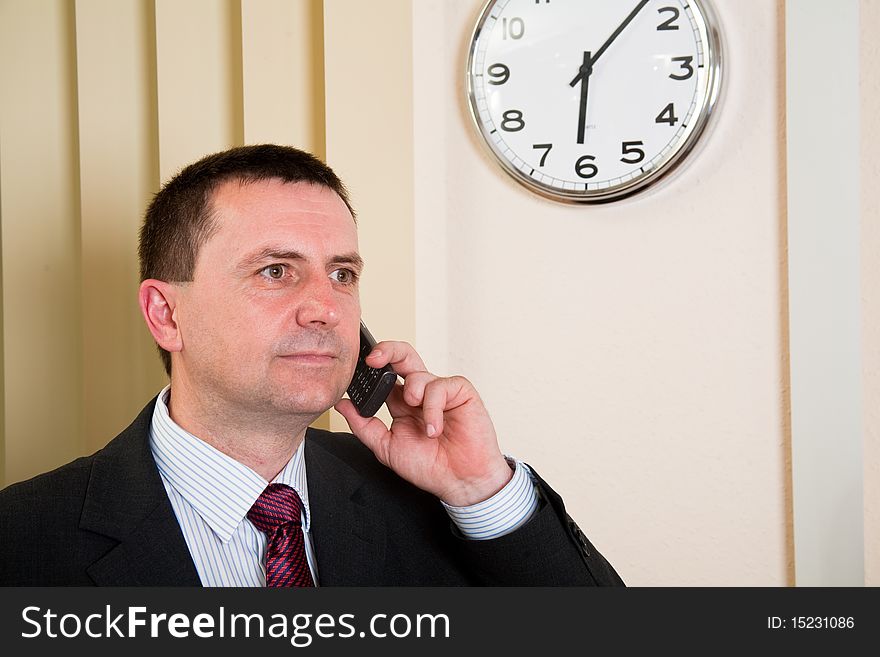 Successful businessman talking on a cell phone. Successful businessman talking on a cell phone