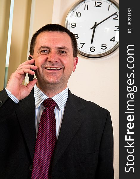 Successful businessman talking on a cell phone. Successful businessman talking on a cell phone