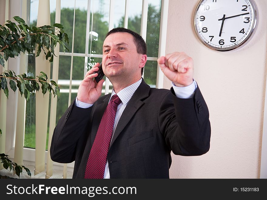 Successful businessman talking on a cell phone. Successful businessman talking on a cell phone