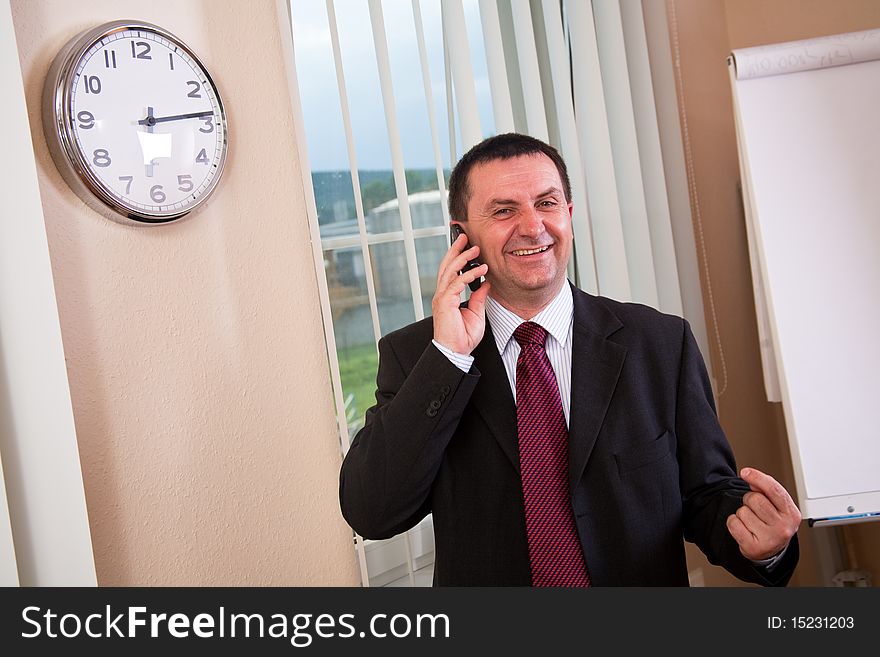 Successful businessman talking on a cell phone. Successful businessman talking on a cell phone