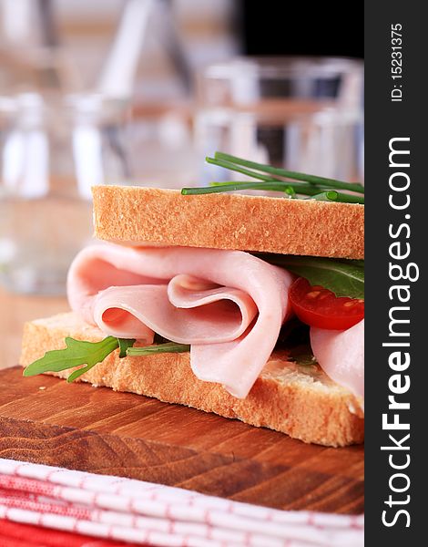 Detail of ham sandwich on a cutting board