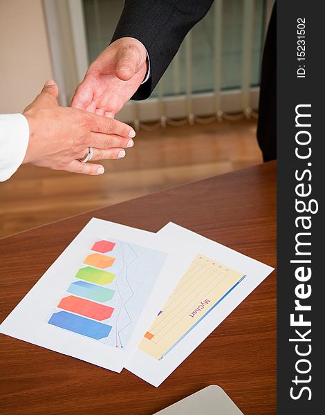 Businessman and woman shaking hands at meeting. Businessman and woman shaking hands at meeting