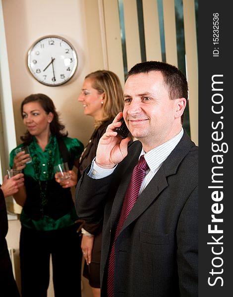 Business man on phone at meeting, women having conversation. Business man on phone at meeting, women having conversation