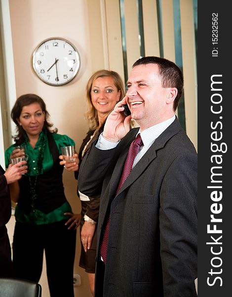 Business man on phone at meeting, women having conversation. Business man on phone at meeting, women having conversation