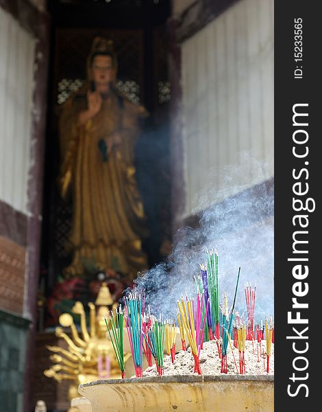 Burning incense for Guan Yin, Krabi Thailand