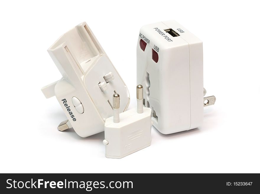 An disassembled universal plug adapter isolated on white background. An disassembled universal plug adapter isolated on white background.