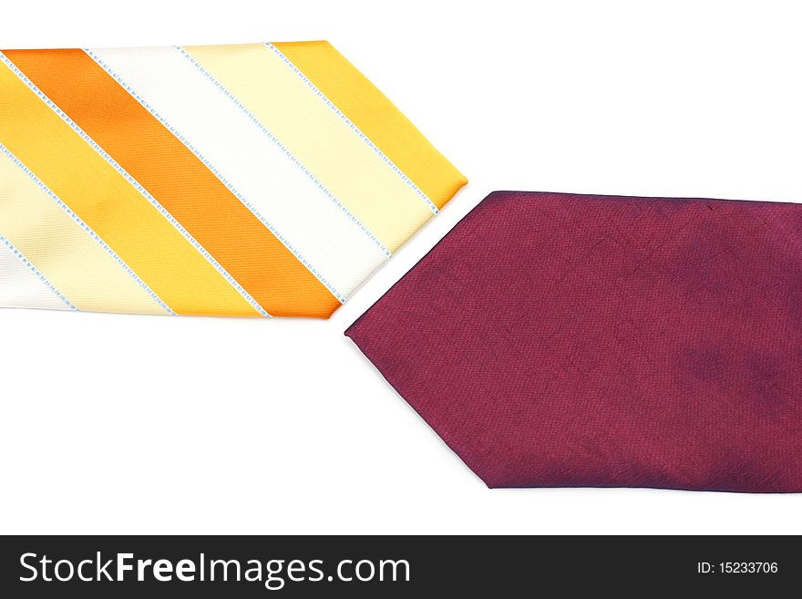 Close up of purple and orange necktie with stripes on white background. Close up of purple and orange necktie with stripes on white background.