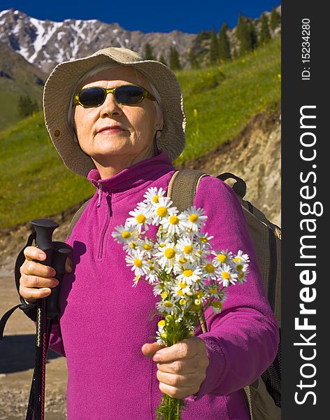 Old women with mountains flowers. Old women with mountains flowers