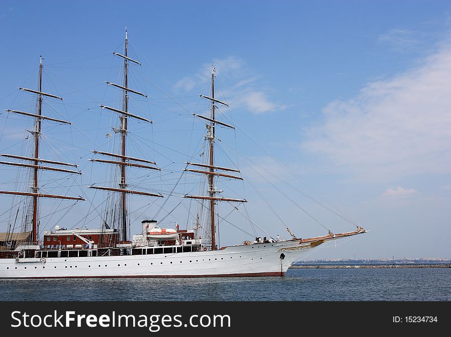 White passenger sailing ship against blue sky