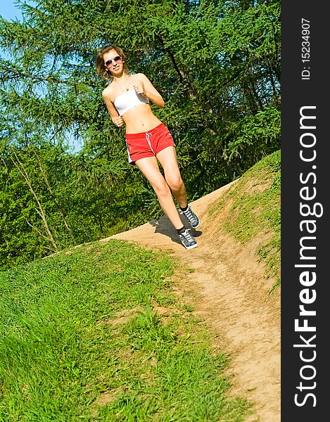 Young woman running in park. Young woman running in park