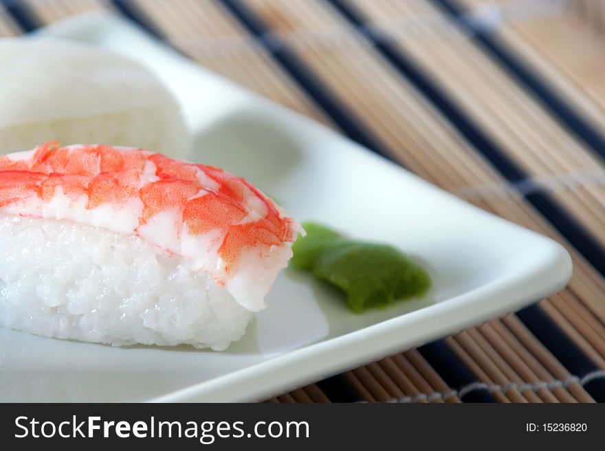 Sushi made of a prawn on a bed of rice and wasabi, detail. Sushi made of a prawn on a bed of rice and wasabi, detail