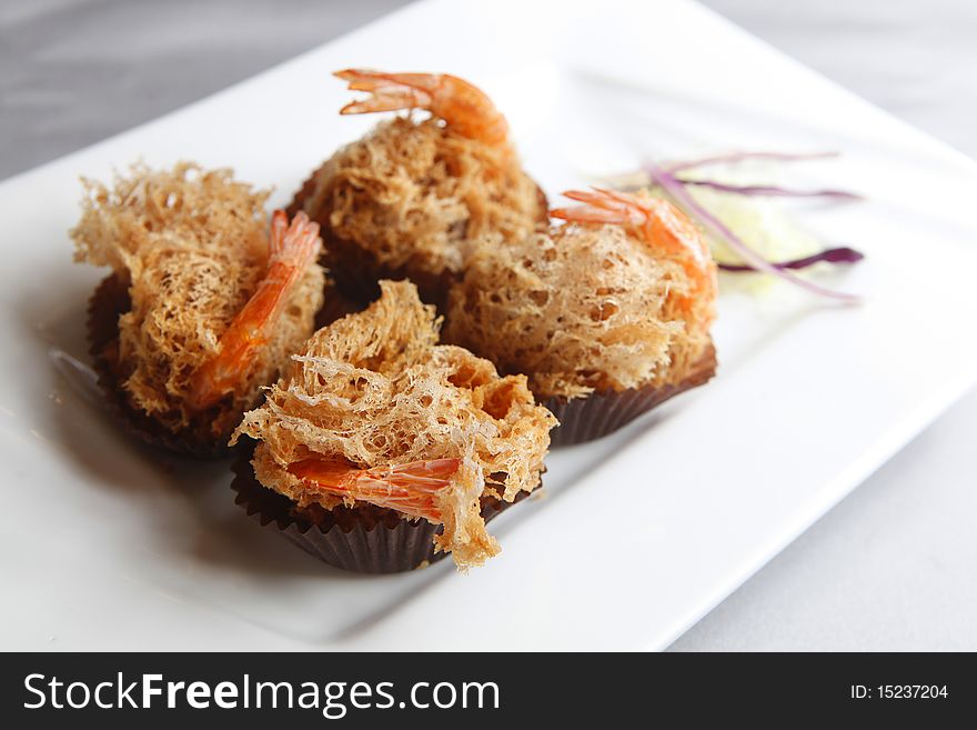 Fried shrimp with decoration in the dish.