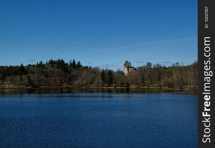 Looking across the lake towards the Chateaux at Sedieres in the correze are of Limousin France. Looking across the lake towards the Chateaux at Sedieres in the correze are of Limousin France