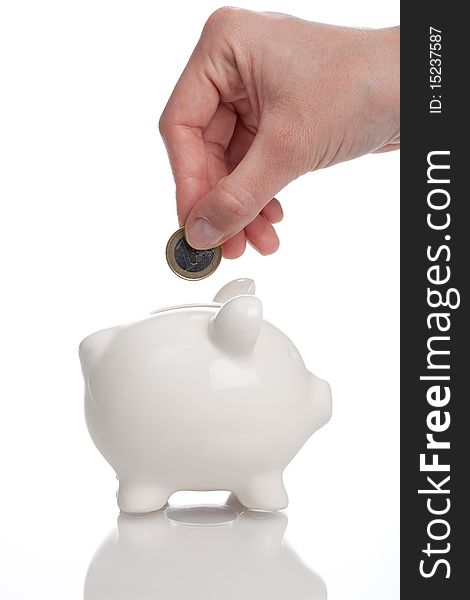 Feeding the piggy bank - isolated on a white background