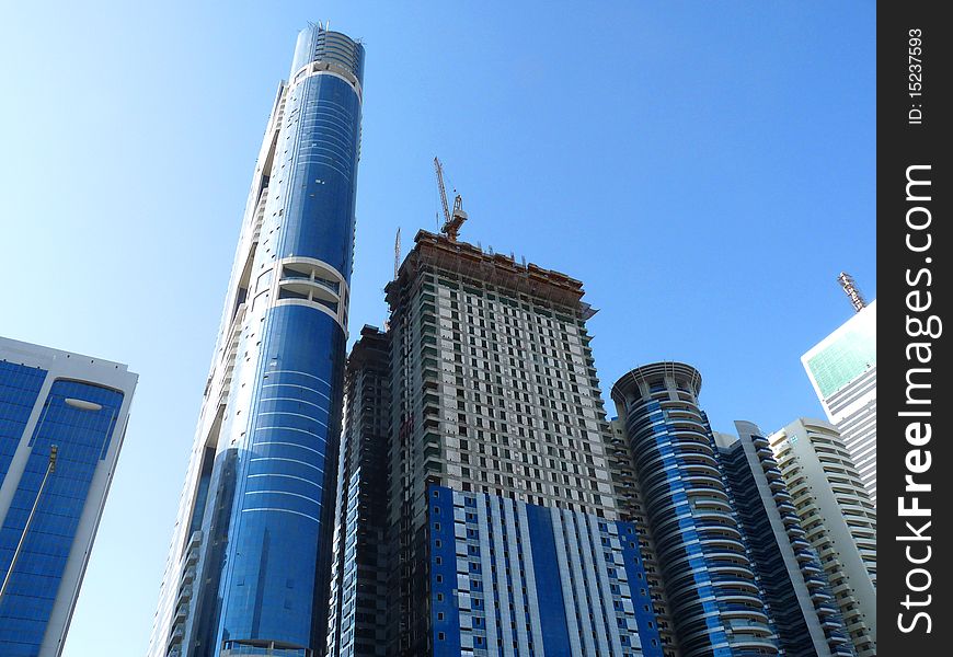 Blue mirrored high rise buildings under construction. Blue mirrored high rise buildings under construction