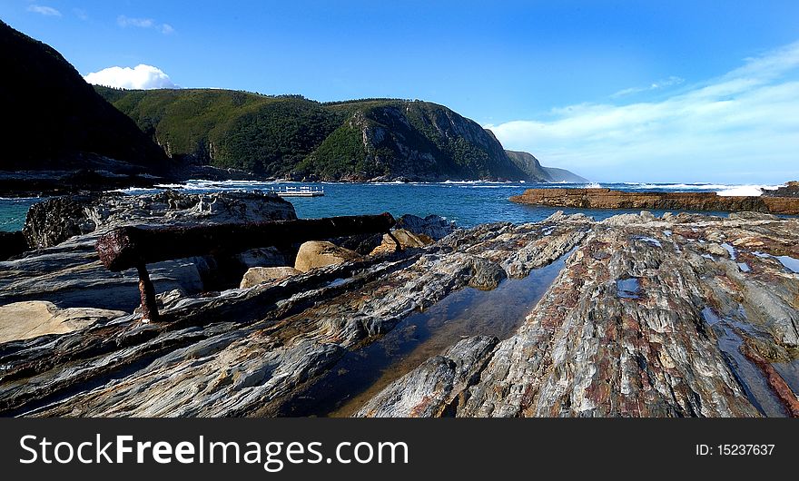 Rocky beach seascape with a scenic mountain view. Rocky beach seascape with a scenic mountain view