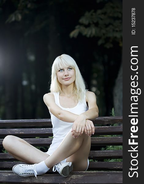 Young woman having rest on the bench. Young woman having rest on the bench