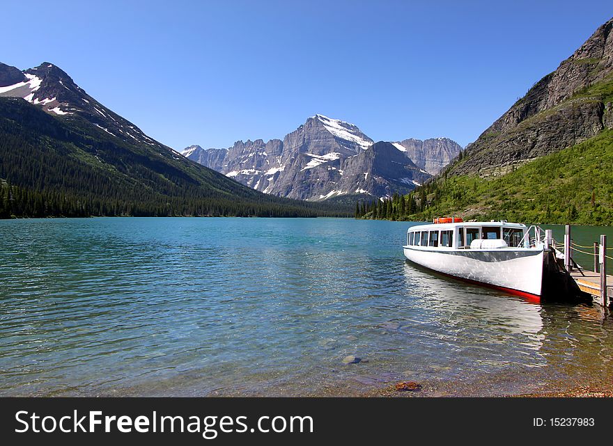 Passenger boat in scenic lake Josephine in Glacier national park