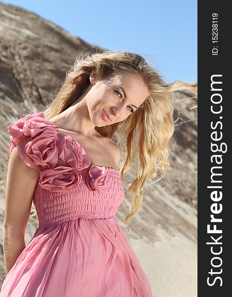 Beautiful blond girl in the dress with pink roses. Beautiful blond girl in the dress with pink roses