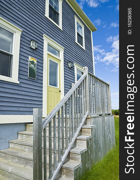 A traditional clapboard home with dramatic blue sky. A traditional clapboard home with dramatic blue sky.