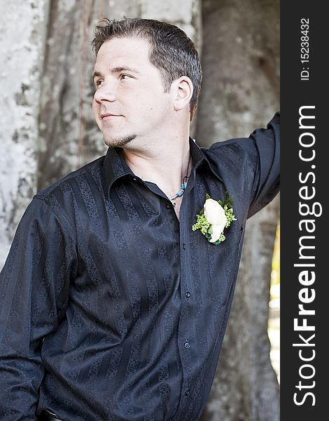 A half portrait of a handsome groom looking away on his wedding day. A half portrait of a handsome groom looking away on his wedding day.