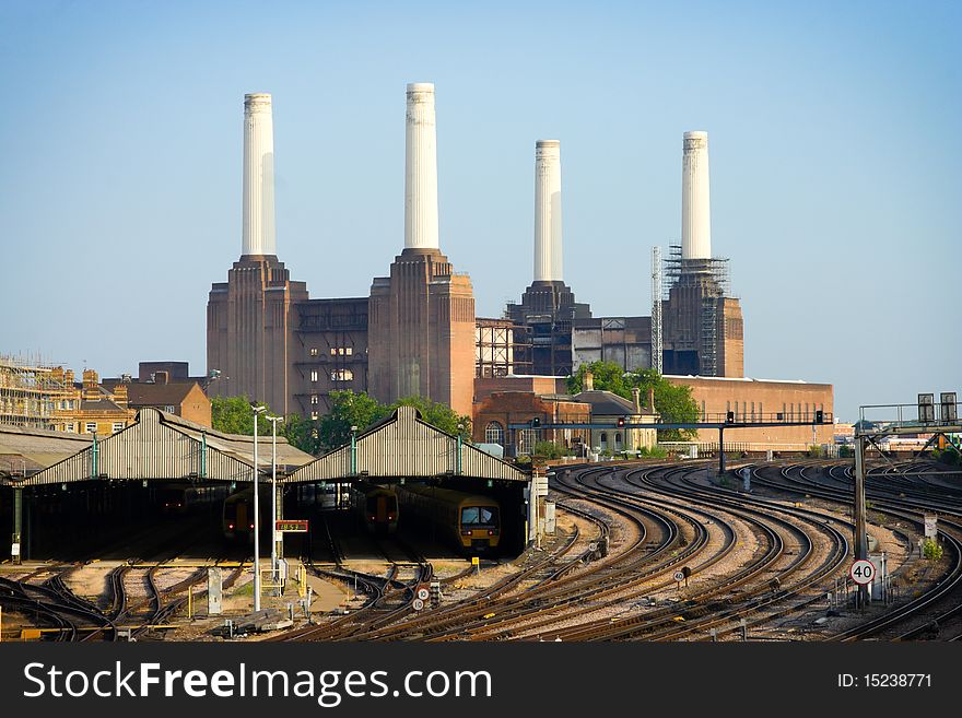 Trains in angars with rails and power station on background, London. Trains in angars with rails and power station on background, London