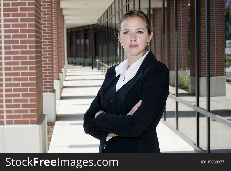 Attractive businesswoman with arms crossed looking at camera