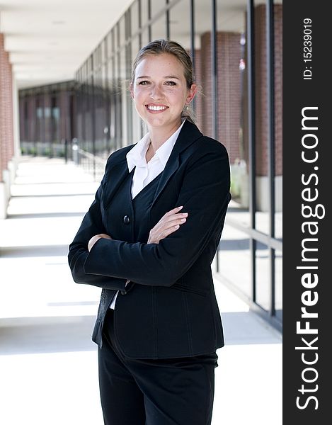 Attractive businesswoman with arms crossed and smiling