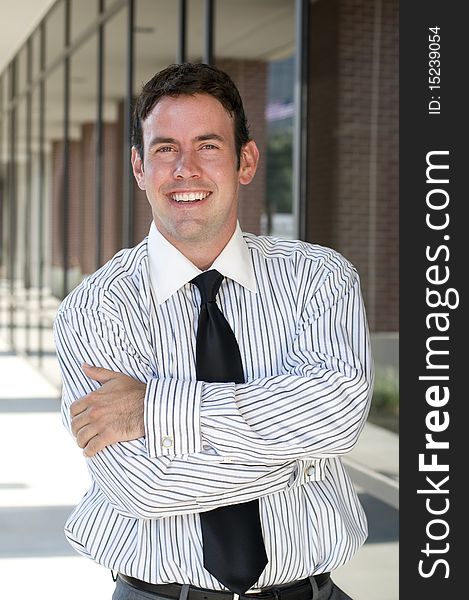 Handsome businessman with arms crossed and smiling