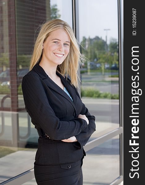 Attractive businesswoman with arms crossed and smiling