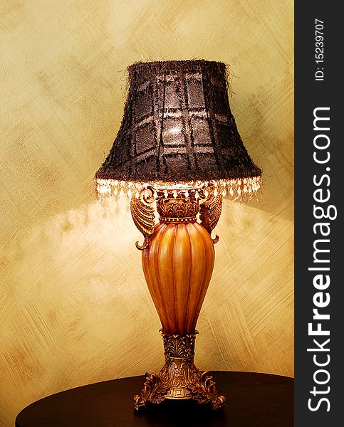 A vintage lamp on a dark wooden table