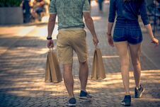 Men And Women Walk Down The Street With Shopping Bags Stock Photo Men And Women Walk Down The Street With Shopping Bags Stock Photo