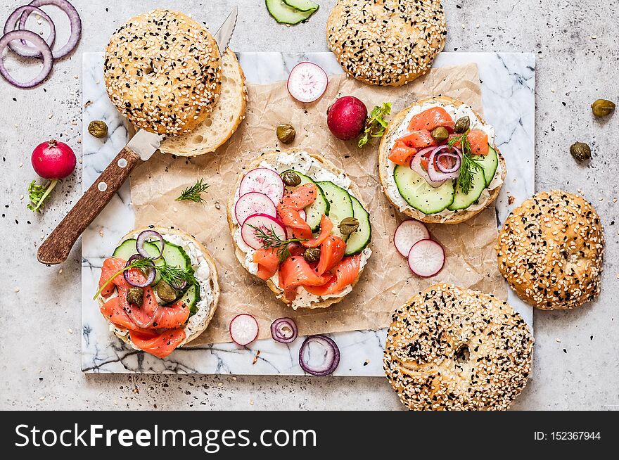 Bagel Sandwiches with Cream Cheese, Salmon and Vegetables, copy space for your text. Bagel Sandwiches with Cream Cheese, Salmon and Vegetables, copy space for your text