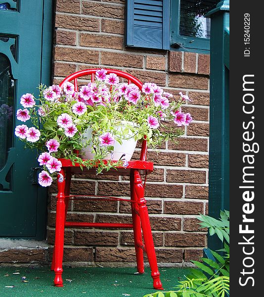 Red wooden chair with flower pot. Red wooden chair with flower pot