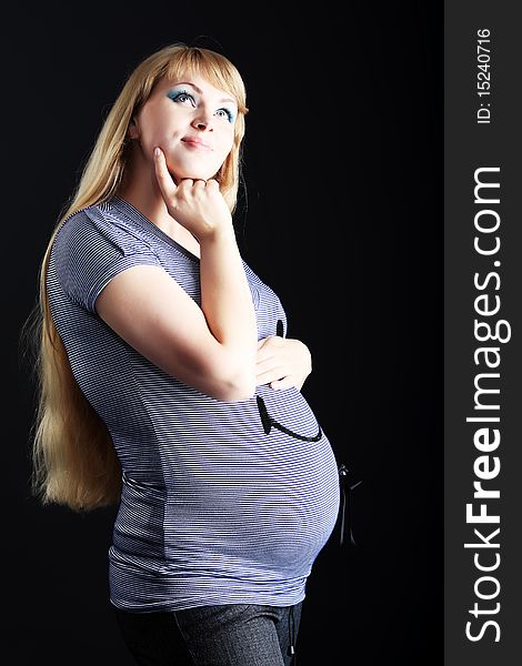 Portrait of pregnant woman posing against black  background. Portrait of pregnant woman posing against black  background.