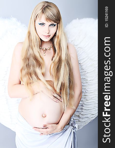 Portrait of a beautiful angelic pregnant woman. Portrait of a beautiful angelic pregnant woman.