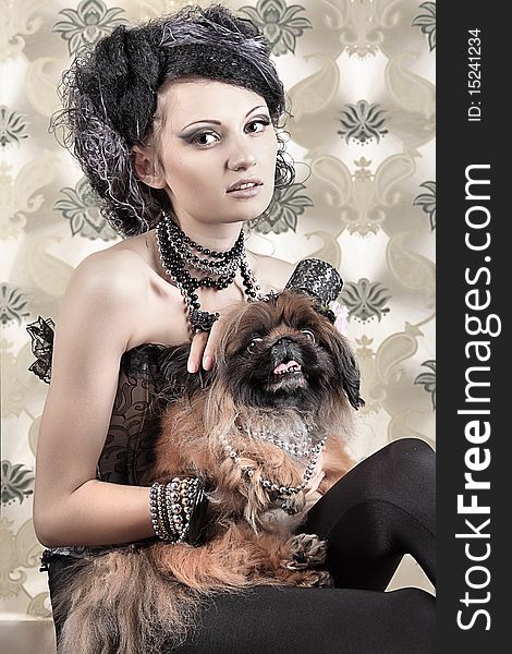 Portrait of a fashionable lady with a dog over vintage background. Portrait of a fashionable lady with a dog over vintage background.